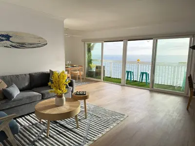 a living room with a couch and a view of the ocean at Redondo Oceanfront Gem 2BR BA Balcony & Parking 335 in Redondo Beach