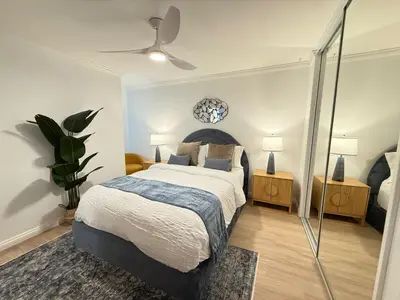 a bedroom with a bed and a ceiling fan at Redondo Oceanfront Gem 2BR BA Balcony & Parking 335 in Redondo Beach