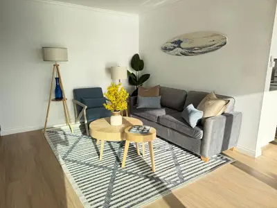 a living room with a couch and a table at Redondo Oceanfront Gem 2BR BA Balcony & Parking 335 in Redondo Beach
