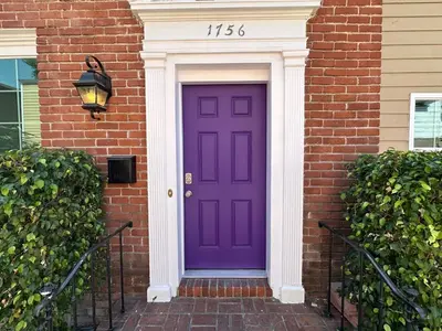 a purple door on a brick house with a sign on it at Walk of Fame 1 Bedroom with shared bathroom and kitchen in Los Angeles