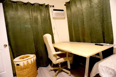 a room with a table and a green curtain at Walk of Fame 1 Bedroom with shared bathroom and kitchen in Los Angeles