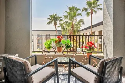 a balcony with chairs and a table with flowers at Lux Oasis in Woodland Hills in Los Angeles