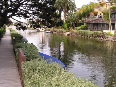 a river with a blue boat on it at Venice Canals Contemporary, unique wildlife, amazing reviews in Los Angeles