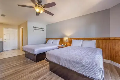 a bedroom with two beds and a ceiling fan at Big Bear Lakefront Lodge in Big Bear Lake