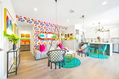 a living room with a swing and a kitchen at B- InstaWorthy & Family-Friendly NoHo Gem- Near Universal & Hollywood with Parking, Games, and Hot Tub in North Hollywood