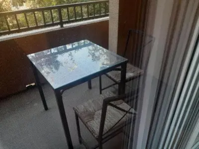 a table and a chair on a balcony at Great place for good night rest in Anaheim