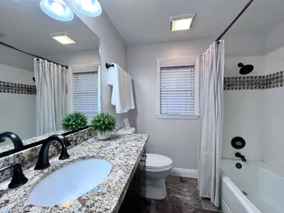 a bathroom with a sink and a toilet and a tub at Sensational 6 Bedroom 4 Bathroom Pool Home (3 Master Bedrooms W/bathrooms) in Anaheim