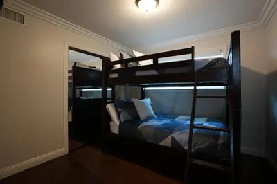 a bedroom with two bunk beds in a room at Highly Upgraded, 5 Bed, 45 ba, New Pool w/Jacuzzi, 1/2 mile walk to Disney in Anaheim