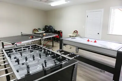 two ping pong tables in a room with ping pong balls at Stunning 8 bedroom 6 bathroom Pool Home in Anaheim
