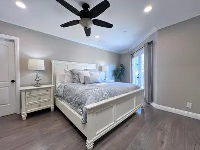 a bedroom with a bed with a ceiling fan at Stunning 8 bedroom 6 bathroom Pool Home in Anaheim