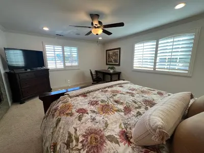 a bedroom with a bed and a ceiling fan at Amazing Large Family Home w/Pool, 1 Mile to Disney in Anaheim