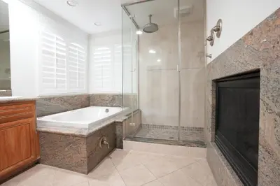 a bathroom with a tub and a glass shower at Amazing Large Family Home w/Pool, 1 Mile to Disney in Anaheim