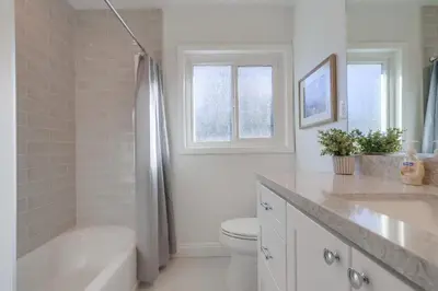 a bathroom with a tub and a toilet and a sink at Beautiful Remodel 3 Bedroom 2 bathroom Home with Pool & Jacuzzi in Fullerton