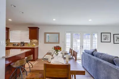a living room with a table and a blue couch at Beautiful Remodel 3 Bedroom 2 bathroom Home with Pool & Jacuzzi in Fullerton