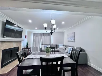 a living room with a table and a couch at Luxurious 2 Bedroom Condo Shortest Walk To Disney in Anaheim