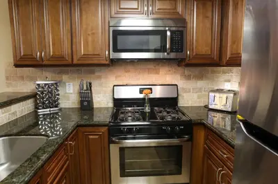 a kitchen with a stove and a microwave at Luxurious 2 Bedroom Condo Shortest Walk To Disney in Anaheim