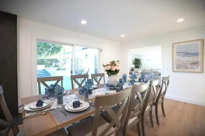 a dining room with a long table and chairs at Awesome 5 bedroom 3 bath pool home with in-ground jacuzzi in Orange