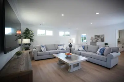 a living room with two couches and a coffee table at Awesome 5 bedroom 3 bath pool home with in-ground jacuzzi in Orange