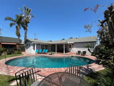a swimming pool in the backyard of a house at Anaheim California, Beautiful Pool Home, Short Walk to Disney in Anaheim
