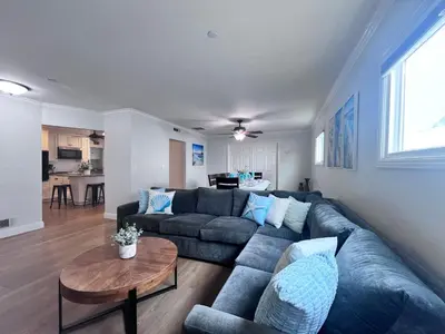 a living room with a couch and a table at Anaheim California, Beautiful Pool Home, Short Walk to Disney in Anaheim