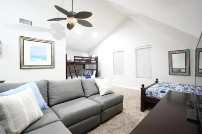 a living room with a couch and a ceiling fan at Sweet 4 bedroom, 3 bath plus Loft Bedroom, Pool Home in Anaheim