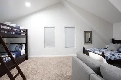 a bedroom with two bunk beds and a couch at Sweet 4 bedroom, 3 bath plus Loft Bedroom, Pool Home in Anaheim
