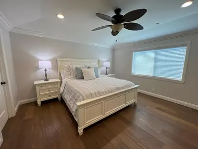 a bedroom with a bed and a ceiling fan at Fantastic 6 bedroom, 45 bath home (4 master Suites), pool home in Anaheim