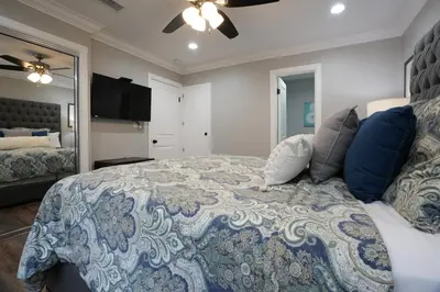 a bedroom with a large bed with pillows on it at 4 bedroom, 3 bathrooms Pool Home in Orange