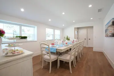 a white dining room with a table and chairs at 4 bedroom, 2 bathrooms in Orange