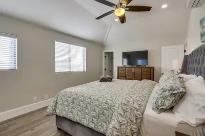 a bedroom with a bed and a ceiling fan at 5 Bedroom plus loft room, 3 Bath home in Fullerton