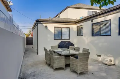 a patio with a table and chairs in front of a house at 5 Bedroom plus loft room, 3 Bath home in Fullerton