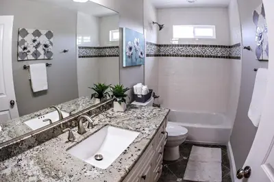 a bathroom with a sink and a toilet and a tub at Adorable 3 Bedroom 2 Bath Home in Fullerton