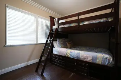 a bedroom with two bunk beds and a window at Charming Anaheim Home 1/2 Mile Walk to Disney in Anaheim