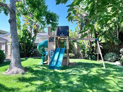 a playground in a yard with a slide at Charming Anaheim Home 1/2 Mile Walk to Disney in Anaheim