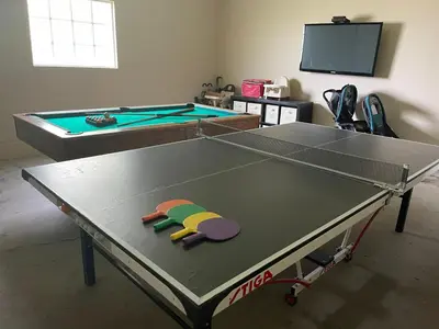 a ping pong table with a ping pong ball on it at Gorgeous Pool Home 1/2 Mile Walk to Disney in Anaheim