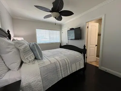 a bedroom with a bed with a ceiling fan at Gorgeous Pool Home 1/2 Mile Walk to Disney in Anaheim