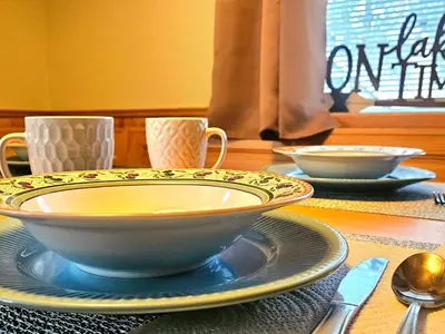 a table with a bowl on a plate on a table at 3BR Home w Game Room by The Village, Lake & Summit in Big Bear Lake