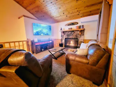 a living room with a couch and a fireplace at 3BR Home w Game Room by The Village, Lake & Summit in Big Bear Lake