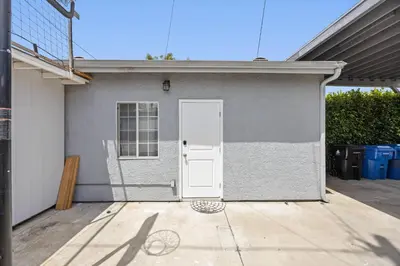 a white door of a house with a driveway at Cozy Backhouse Stay – Sleeps 2 Beverly Hills Adj in Los Angeles