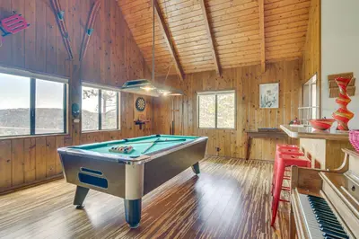 a pool table in a room with wooden walls at Partial Lake Arrowhead View Cabin with Game Room! in Lake Arrowhead