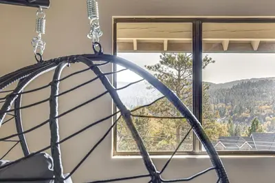 a window with a view of a mountain at Partial Lake Arrowhead View Cabin with Game Room! in Lake Arrowhead