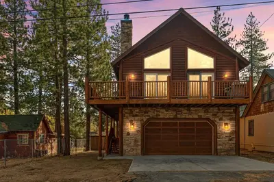 a house with a balcony on top of it at Llama Bear Lodge with Hot Tub in Big Bear Lake