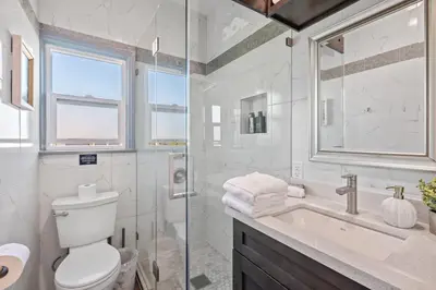 a bathroom with a toilet and a sink and a shower at Luxury Beachside Gem Walk to Beach Ocean Views in Manhattan Beach