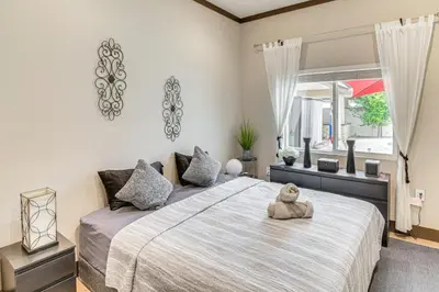 a bedroom with a large bed with a teddy bear sitting on it at Private Pool and Sauna Pet-Friendly Reseda Retreat! in Reseda