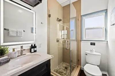 a bathroom with a sink and a toilet and a shower at Newly Remodeled Cozy Beach Retreat Ocean Views in Manhattan Beach