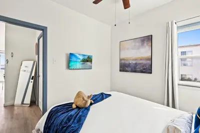 a bedroom with a teddy bear sitting on a bed at Newly Remodeled Cozy Beach Retreat Ocean Views in Manhattan Beach