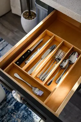 a wooden tray with utensils in a drawer at Newly Remodeled Cozy Beach Retreat Ocean Views in Manhattan Beach