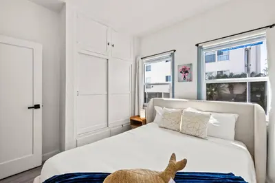 a bedroom with a bed with a stuffed animal on it at 2BR Luxury Getaway Mins to Beach Arcade & Games in Manhattan Beach