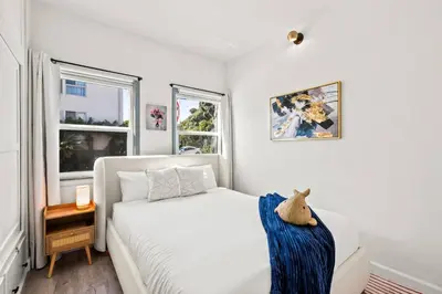 a bedroom with a white bed and two windows at 2BR Luxury Getaway Mins to Beach Arcade & Games in Manhattan Beach