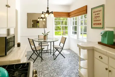 a kitchen and dining room with a table and chairs at Enchanting Hollywood Hills Oasis with Tree-Top Views, Serene Outdoor Living Room, Zen Garden, Free Attached Garage, Sleeps 6, in LA's Most Desirable, Central, Serene Canyon Neighborhood, and Only 2 Minutes to Hollywood Boulevard in Los Angeles